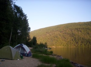 two tents pitched by a lake